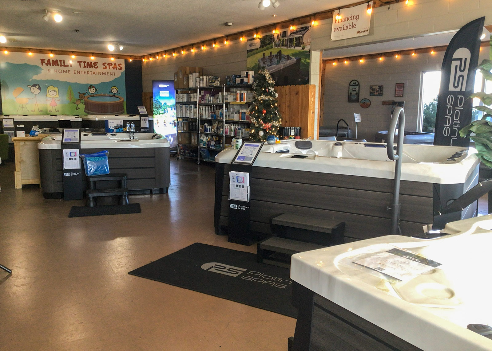 Interior of the Family Time Spas showroom in Grand Junction, featuring multiple hot tubs on display, spa accessories, and a welcoming retail space.
