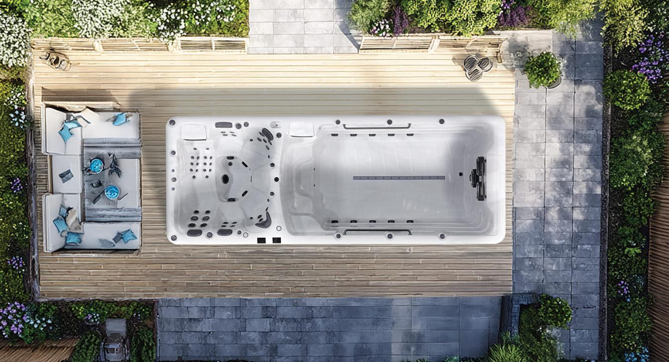 Overhead view of a swim spa showing built-in seating, massage jets, and swimming area.