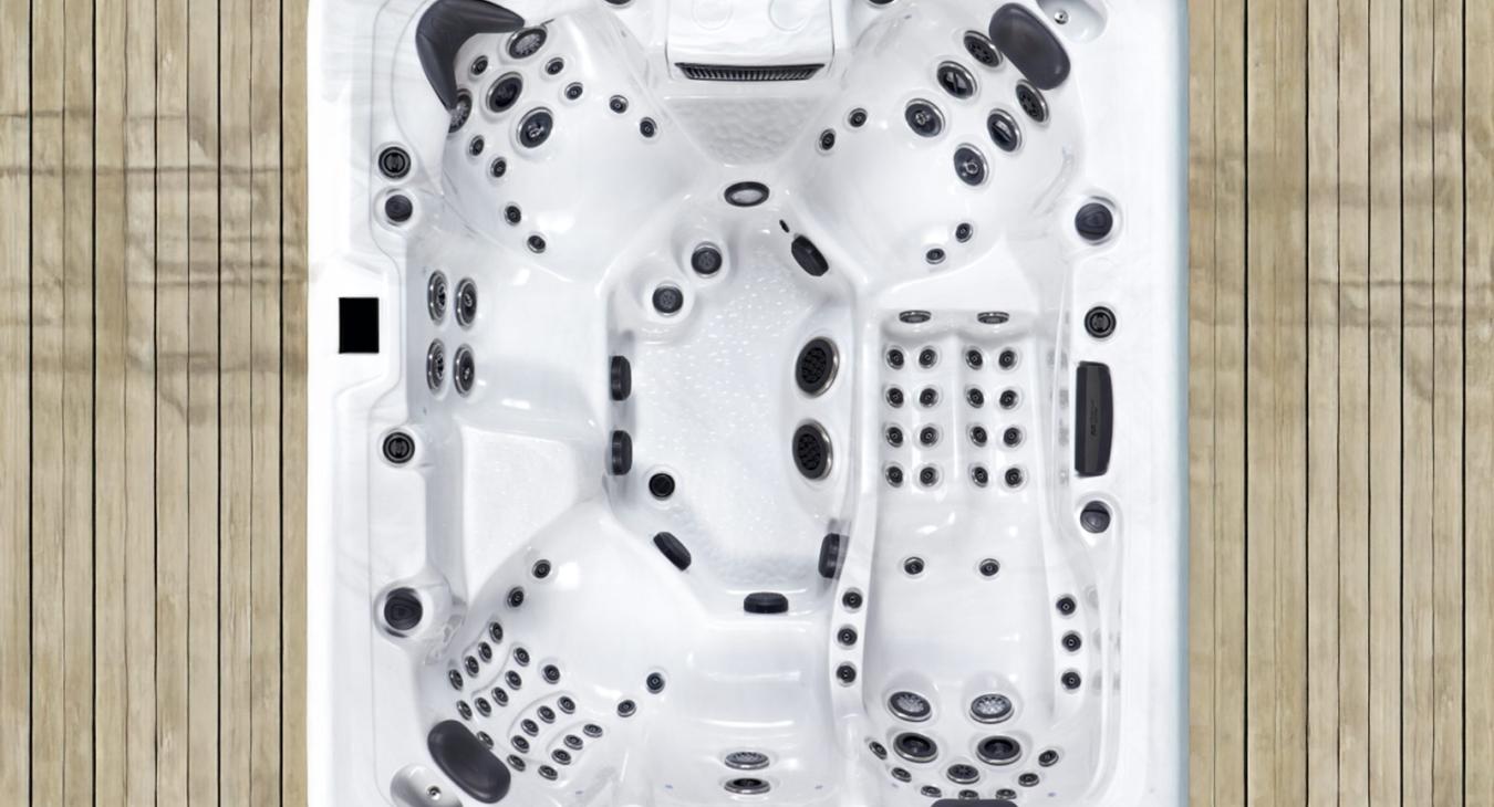 Top-down view of a large hot tub highlighting multiple seating positions and massage jet layout.