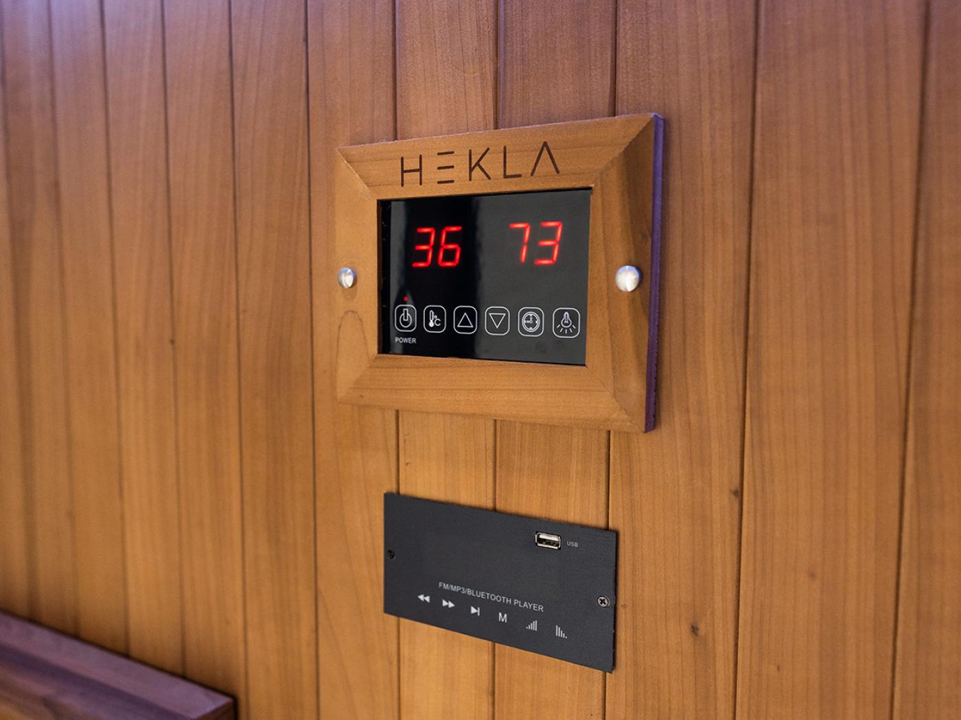 Hekla infrared sauna digital control panel displaying temperature and settings with built-in Bluetooth audio system
